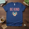 BE KIND t-shirt with hands holding a heart and radiating light, inspirational quote design