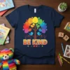 Be Kind t-shirt with a rainbow tree and two blue birds, featuring bold orange text that says BE KIND