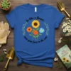 Be like a flower turn your face to the sun quote with sunflower and daisies graphic on blue t-shirt