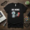 Be Mine robot t-shirt design featuring a cute robot holding an open heart with the Earth inside, white text "BE
