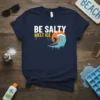 Be Salty Melt Ice t-shirt design featuring a surfer on a wave with melting ice effect