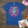 Be Strong You Never Know Who You're Inspiring text with pink ribbons on a blue t-shirt