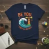 Be You They'll Adjust t-shirt with a lighthouse and ocean wave graphic, featuring musical notes and bright colors