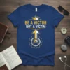 Be A Victor Not A Victim quote t-shirt with motivational arrow and gear graphic