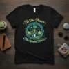 Black t-shirt with "Be The Peace The World Needs" text and a circular peace symbol graphic containing diverse people and