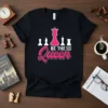 Black t-shirt with "Be The Queen" text and chess pieces graphic, featuring a pink queen piece