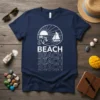 Navy t-shirt with repeating white text "BEACH BEACH BEACH BEACH" and a circular graphic of a sunset, palm trees, anchor