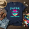 Beach Bum Tropical Paradise t-shirt design with palm trees and ocean scene