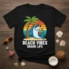 Beach Vibes Shark Life text design with a cartoon shark wearing sunglasses holding a coconut drink under a palm tree