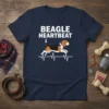 BEAGLE HEARTBEAT t-shirt design featuring a beagle dog on a heartbeat EKG line, white text, navy shirt