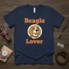 Beagle Lover text with a cartoon beagle face illustration on a navy t-shirt
