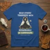 T-shirt with text "Bear Others' Tragedies With Remarkable De-Composure" and a meditating bear graphic, holding a rose