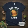 Beardie Mom t-shirt featuring a bearded dragon head inside a green leafy wreath