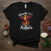 Black t-shirt with "Beauty FROM Ashes ISAIAH 61:3" text and a colorful phoenix graphic, symbolizing rebirth and faith