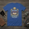 Blue t-shirt with gold and white text reading "Because I'm The DM That's Why" featuring a D20 die and an