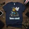 Bee wearing sunglasses and a leather jacket riding a motorcycle with the text "bee cool" below it