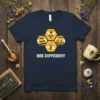 Bee Different quote on a navy t-shirt with cartoon honeycomb bees illustration