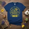 Navy blue t-shirt with yellow text "BEE KIND TO EVRYONE BEE" and a bee with floral graphic