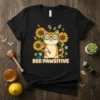 Bee Pawsitive t-shirt design with a cute cat, sunflowers, and bees, featuring the text "BEE PAWSITIVE"
