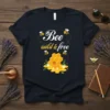 Bee Wild & Free quote t-shirt with a cute bee and honeycomb graphic, white and yellow text on dark fabric