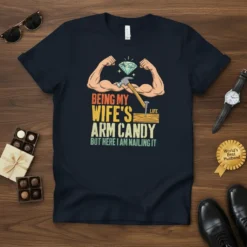 Being My Wife's Arm Candy But Here I Am Nailing It text on a navy t-shirt with cartoon biceps, diamond
