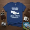 T-shirt with white text "Being a Dad Is An Honor Being a Papa Is Priceless" and graphic of adult hand