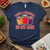 Navy t-shirt with red text "BEING A GRANDMA IS MY JAM" above three cartoon jam jars filled with colorful preserves