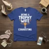 Being A Trophy Wife Is Exhausting text and trophy graphic on a blue t-shirt