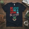 Believe There Is Good In The World quote on a navy t-shirt with globe and hands graphic