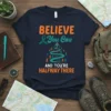Believe You Can And You're Halfway There inspirational quote t-shirt with teal ribbon and climbing figures