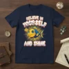 Believe In Yourself And Shine text with a cute angler fish graphic on a navy t-shirt