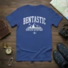 Blue t-shirt with "BENTASTIC" in arching text above mountains, an airplane, and "BENTASTIC ADVENTURES" with a compass graphic