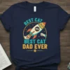 Navy t-shirt with "BEST CAT DAD EVER" text and a cartoon rocket ship graphic, "Best Cat Dad Ever" t-shirt design
