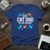 Best Cat Dad In The Galaxy text with blue and orange cats in space theme graphic on navy blue t-shirt