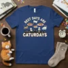 Best Days Are Caturdays text with cute cartoon cats and cityscape design on a navy blue t-shirt