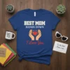 T-shirt design with text "BEST MOM HANDS DOWN I Love You" and hands holding a heart with a halo