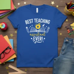 Blue t-shirt with "Best Teaching Assistant Ever!" text, open book, apple, and pencils graphic