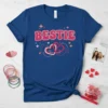 Navy blue t-shirt with "BESTIE" in pink retro font and interlocking pink hearts graphic