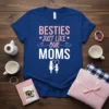 Besties Just Like Our Moms text graphic on a blue t-shirt, featuring two stick figures holding hands with a heart