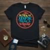 Black t-shirt with colorful text "Better an Oops Than a What If" and airplane graphic, travel theme
