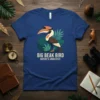 Big Beak Bird Nature's Architect T-Shirt featuring a stylized toucan surrounded by green leaves.| | |