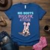 Blue t-shirt with "BIG BOOTS BIGGER ATTITUDE" text and cartoon cowboy boots with a pink bow