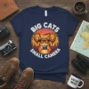 Big Cats Small Camera quote on a navy t-shirt featuring a cat taking photos of lions on safari