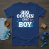 Big Cousin Says Boy text with blue hearts and pink baby feet graphic on a navy blue t-shirt