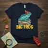 Big Frog T-Shirt with a cartoon frog wearing a beanie sitting on books, text reads BIG FROG