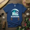 BIG KAHUNA text with a surfer on a wave graphic, two tiki faces below, on a navy t-shirt