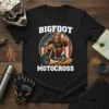 Bigfoot riding a motocross bike with "BIGFOOT MOTOCROSS" text, set against a US flag circle background