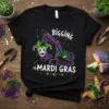 Black t-shirt with "BIGGING MARDI GRAS" text and a purple excavator holding a Mardi Gras mask