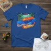 BIGTEETH graphic t-shirt featuring a blue and orange dinosaur-themed monster truck with sharp teeth and palm trees in the background