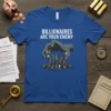 Billionaires Are Your Enemy quote on a blue t-shirt with a graphic of a hand controlling a city